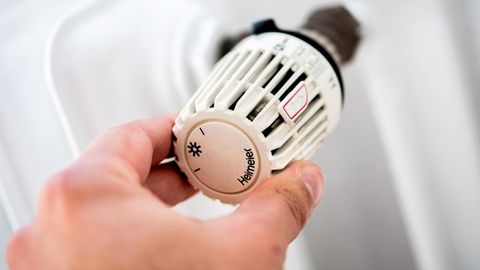 : Ein Mann dreht in einer Wohnung am Thermostat einer Heizung. (zu dpa: "«Wirtschaftsweise»: Mieter brauchen Anreize zum Energiesparen") Foto: Hauke-Christian Dittrich/dpa +++ dpa-Bildfunk +++