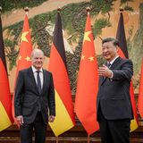 Chinas Präsident Xi Jinping (r) begrüßt den Kanzler