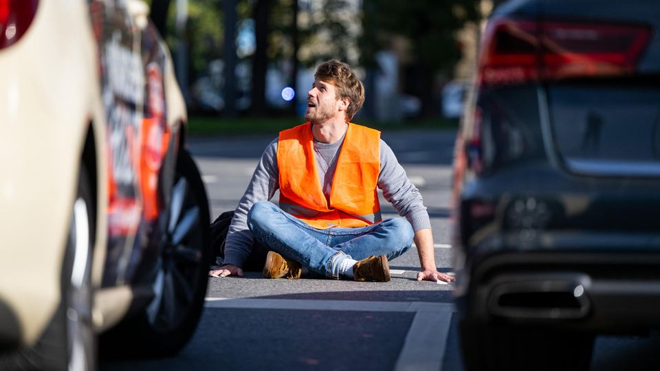 Klimaaktivist klebt sich an Straße