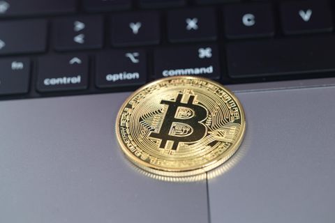 Bitcoin-Münze auf Laptop