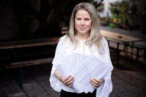 Natascha Sagorski hält mehrere Zettel mit Unterschriften in der Hand. Sie fordert gestaffelten Mutterschutz nach Fehlgeburten.