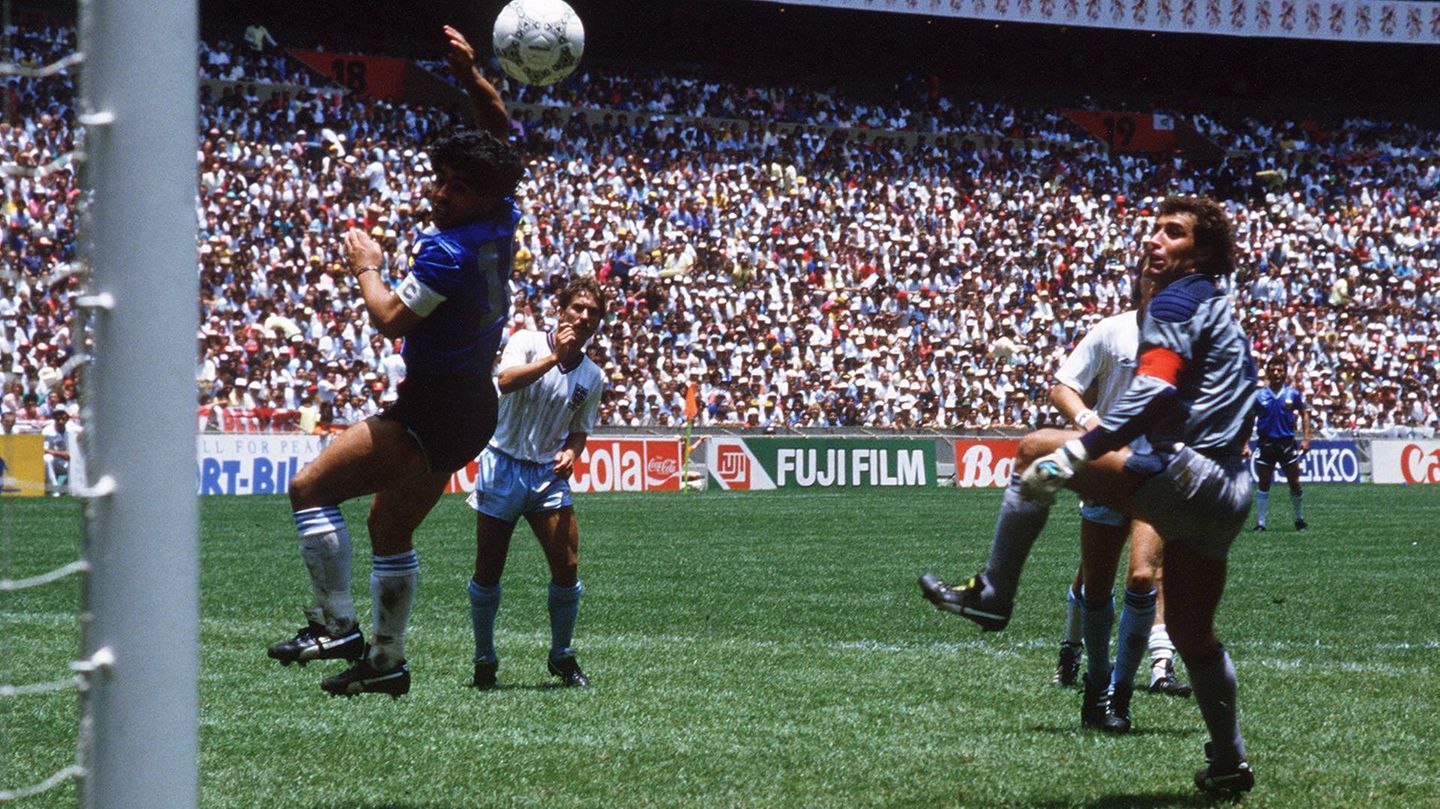 Diego Maradona scores a goal for Argentina with a hand