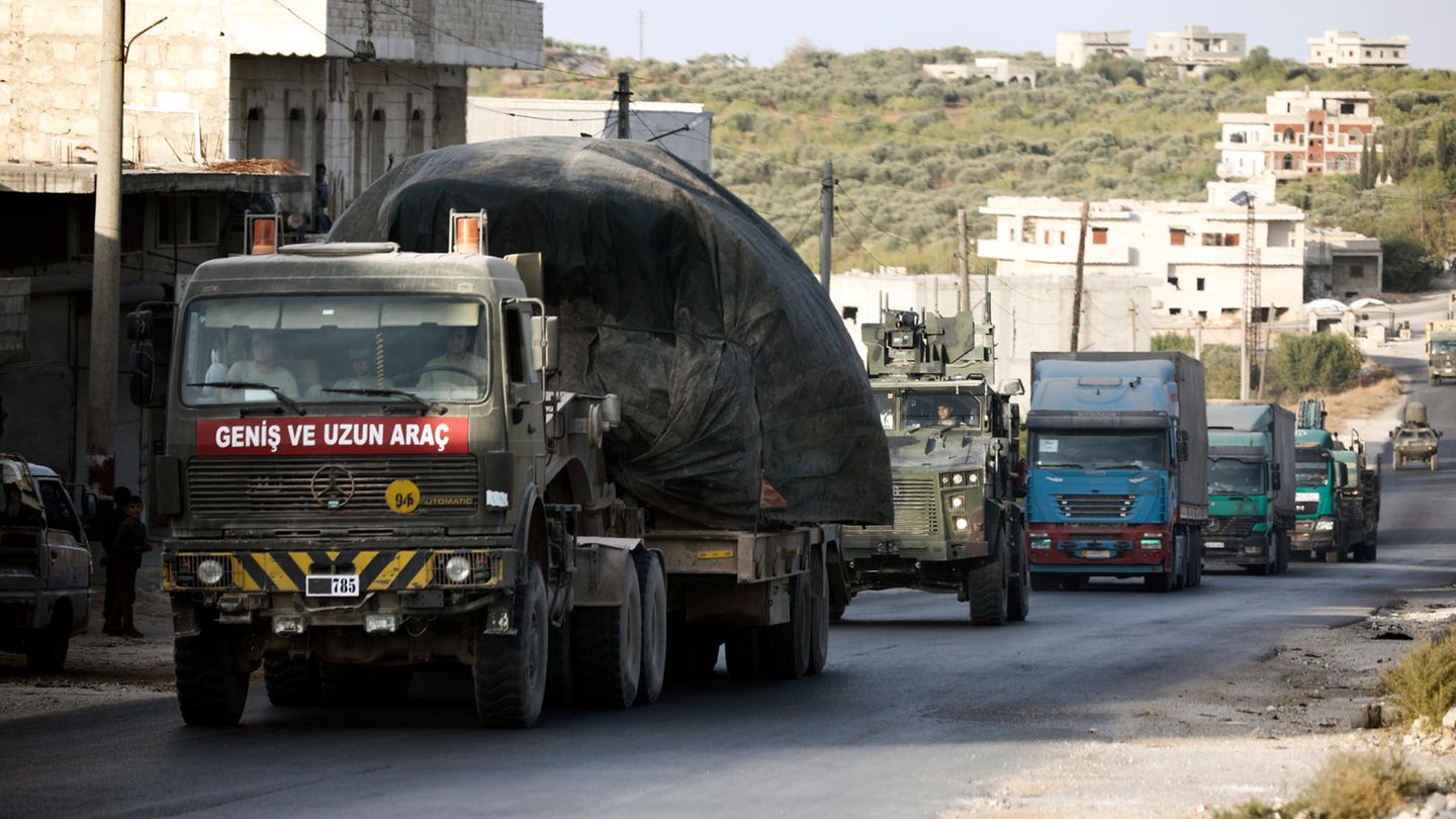 A Turkish military convoy drives through the village of Urum al-Jawz in Syria's Idlib province