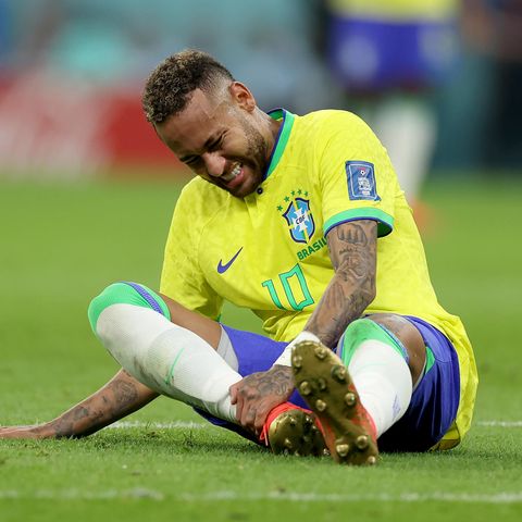 Mit schmerzverzerrtem Gesicht sitzt Neymar im WM-Spiel gegen Serbien auf dem Platz.