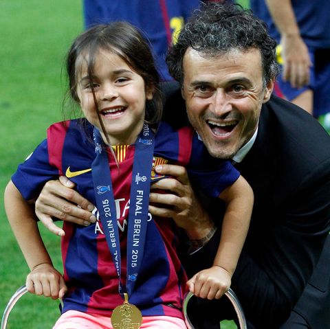Luis Enrique and his daughter Xana, who sits on a trophy
