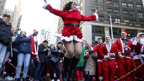 Frau in Weihnachtsmann-Kostüm springt hoch