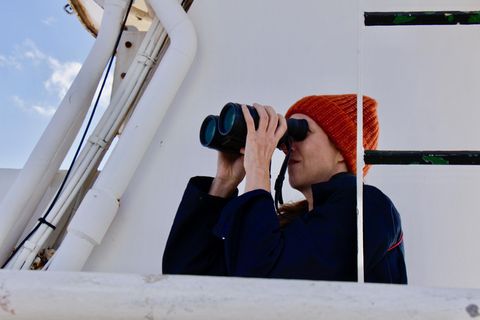 Sina Horsthemke auf dem Peildeck mit Fernglas