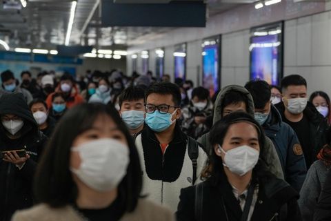 China, Peking: Pendler mit Schutzmasken