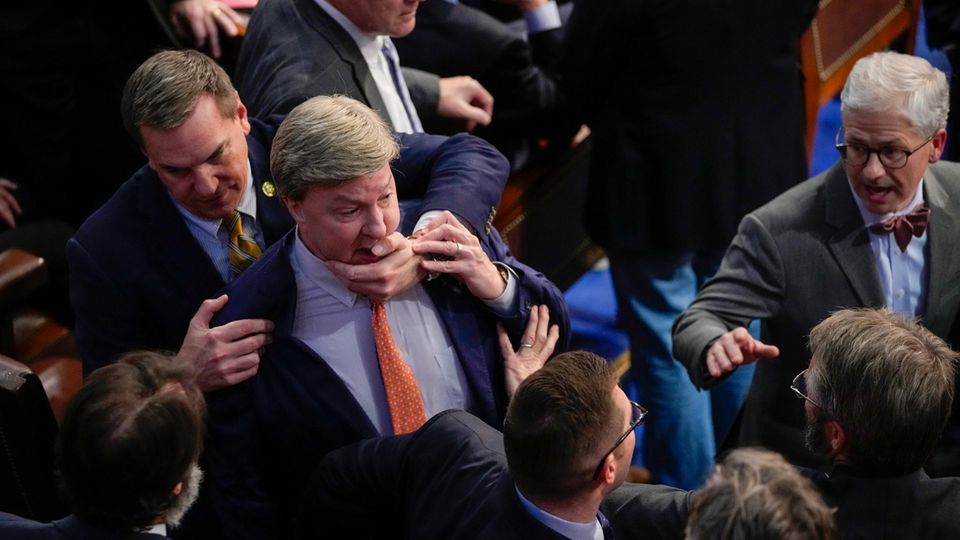 Rep. Richard Hudson (L) retires Rep. Mike Rogers as they speak with Rep. Matt Gaetz and others during the 14th round of voting for the new US House Speaker