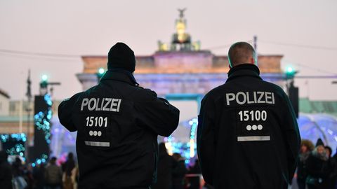 Zwei Polizeibeamten stehen in der Silvesternacht vor dem Brandenburger Tor in Berlin