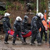 Polizei und Rettungskräfte transportieren ein Person vom Gelände in Lützerath