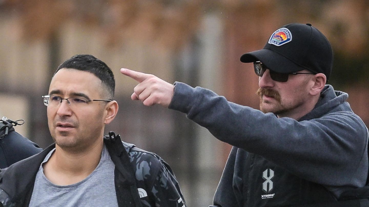 Der Republikaner Solomon Peña geht mit den Armen auf dem Rücken zwischen zwei US-Polizisten mit Schutzwesten und Sonnenbrillen