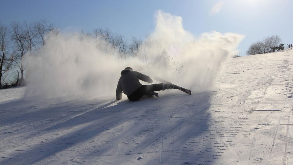 Ein Skifahrer sitzt auf einem verschneiten Hang. Die Apple Watch löst oft Fehlalarme aus.