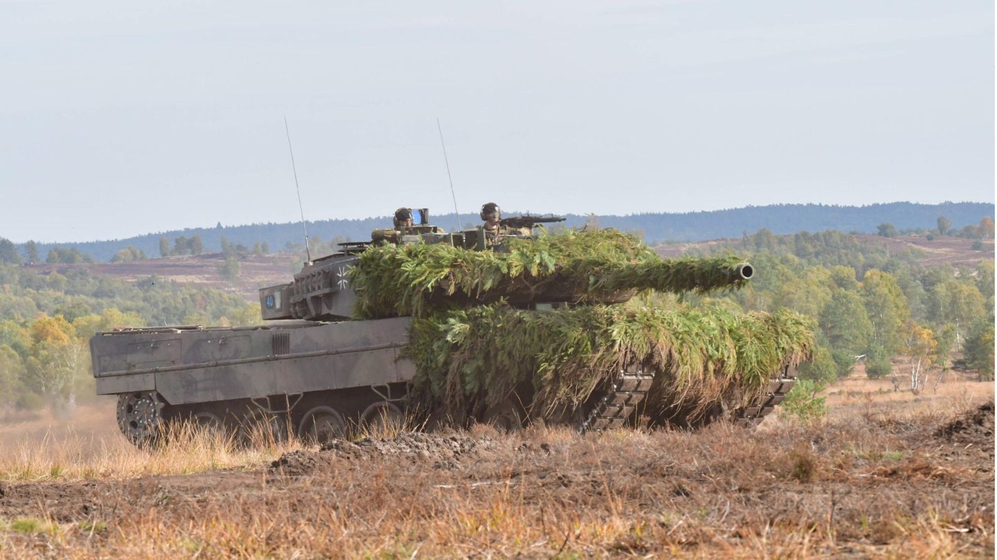Soldiers in a Leopard tank at a military training area