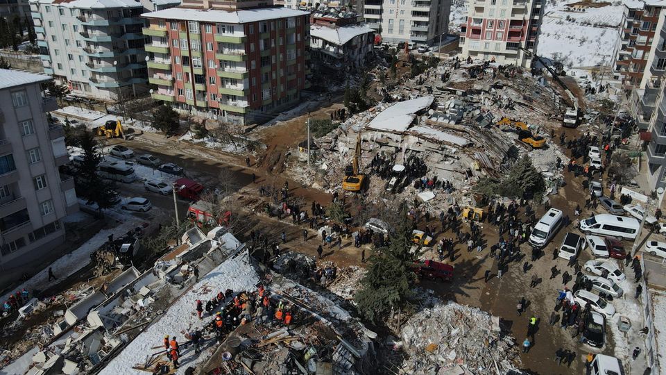 Türkei, Adiyaman: Eine Luftaufnahme zeigt Rettungskräfte und Zivilisten bei der Suche nach Überlebenden in den Trümmern der von den Erdbeben zerstörten Gebäude