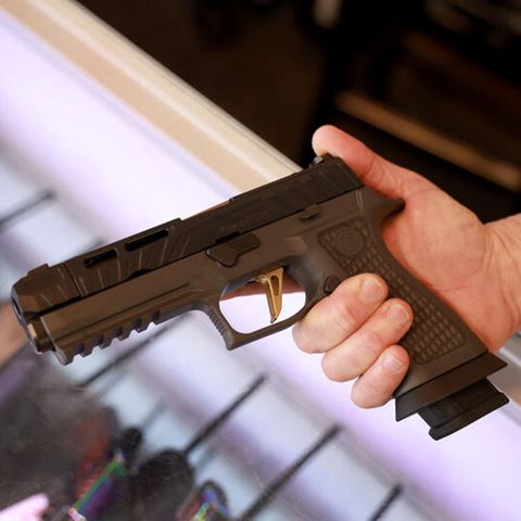 Ein Mann hält eine Sig Sauer P320 Handfeuerwaffe. In Missouri ist das öffentliche Tragen von Waffen erlaubt