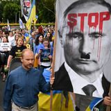 In Sydney versammeln sich Mitglieder der ukrainischen Gemeinde vor der St. Mary's Kathedrale zu einer Mahnwache. Ein Plakat zeigt Russlands Präsident Putin mit Hitlerbart, auf seiner Stirn steht in roter Farbe "Stop".