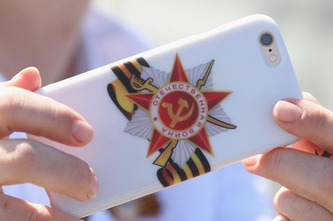 Smartphone mit Hülle, darauf ein patriotisches Symbol