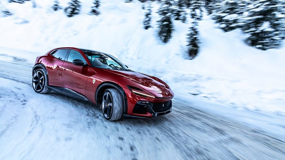 Der Ferrari Purosangue in einer Kurvenfahrt auf schneebedeckter Straße