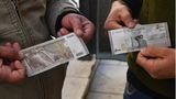 Inflation Syrien: Zwei Männer halten Banknoten in die Kamera