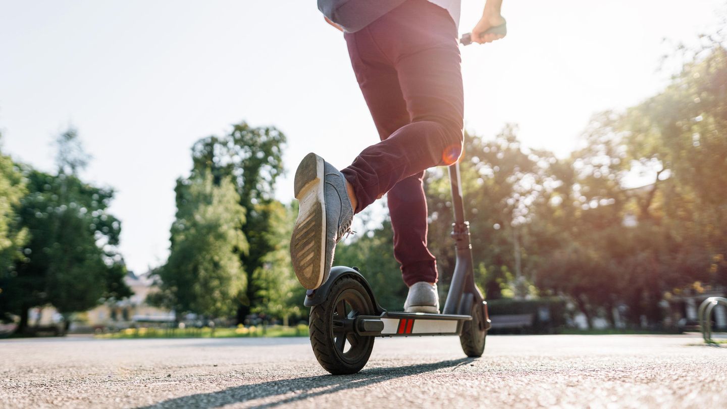 Ein Junge fährt E-Scooter im Park