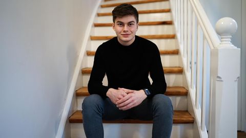 Schüler Liam Kastner sitzt in einem schwarzen Oberteil auf einer Treppe