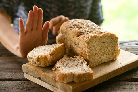 Eine Hand lehnt Weizenbrot ab