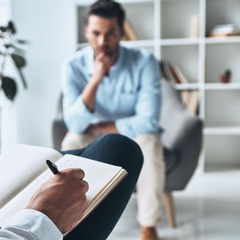 In therapy: a man sits on an armchair, a woman takes notes