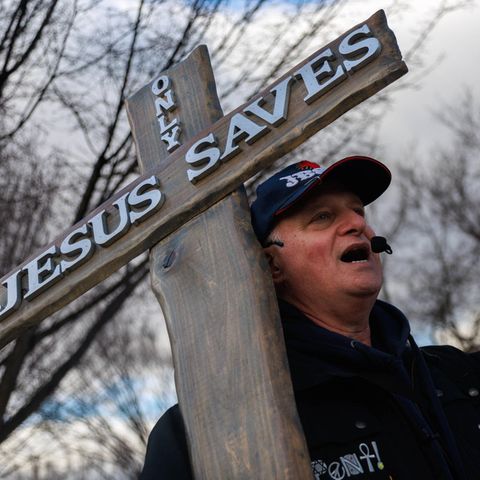 Ein Mann protestiert mit einem Kreuz und einer Bible beim "March for Life" in Washington D.C., USA