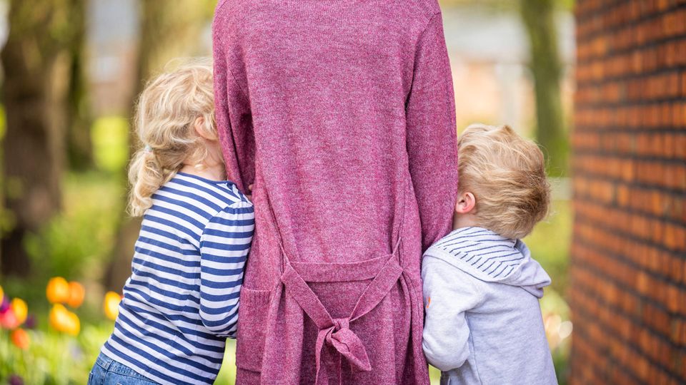 Mutter in der Mitte ihrer zwei Kinder, Symbolbild zum Muttertag