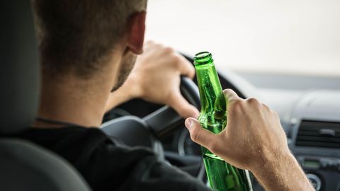 Fahrer trinkt Bier auf der Autobahn