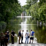 Sackgasse: Menschen in Cherson begutachten eine Straße, die zum Fluss geworden ist