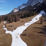 Ähnlich sieht es Mitte Januar in Ehrwald, einem Skigebiet in Österreich, aus: Nur auf einem schmalen Streifen liegt überhaupt Schnee, abseits der beschneiten Piste ist nur Wiese zu sehen.