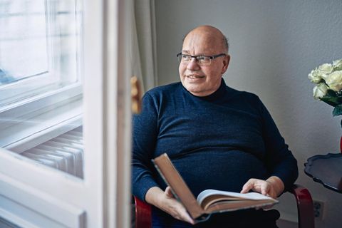 Peter Altmaier mit einem Buch auf dem Schoß