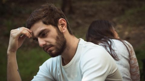 Ein Mann stützt den Kopf auf seiner Hand ab