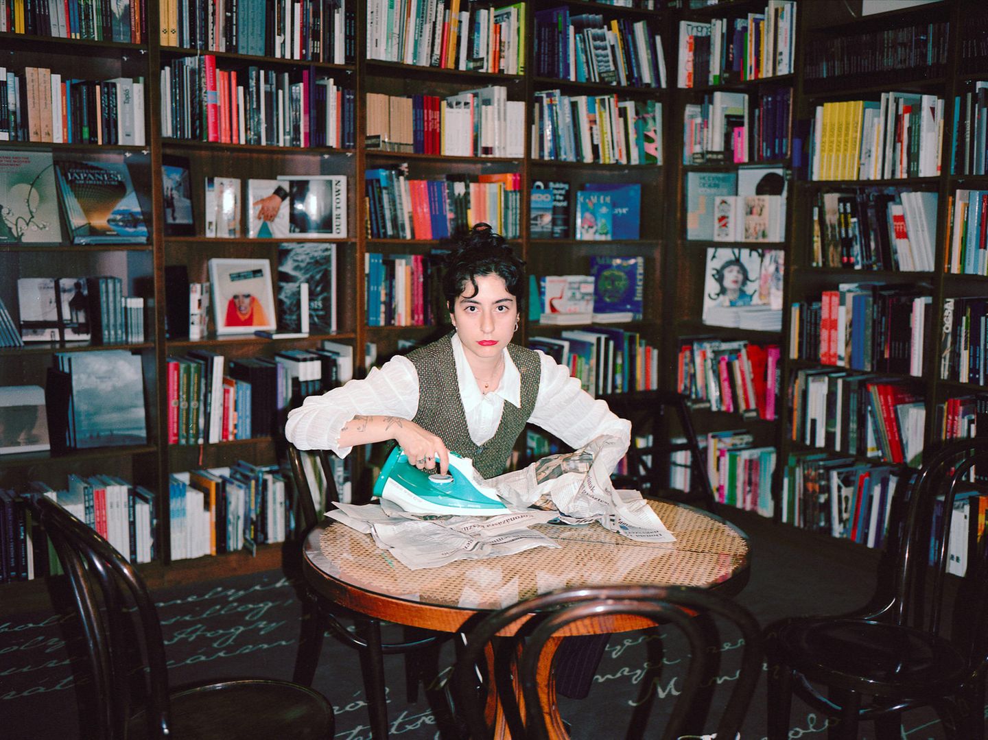 Asli Özçelic bügelt eine Zeitung in einer Bücherei