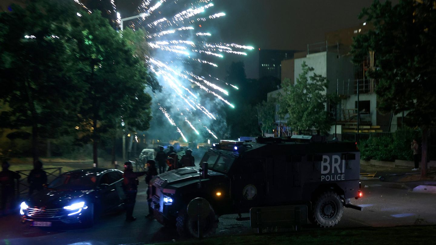 Neben einem gepanzerten Fahrzeug explodiert ein Feuerwerkskörper bei Krawallen in der französischen Hauptstadt Paris.