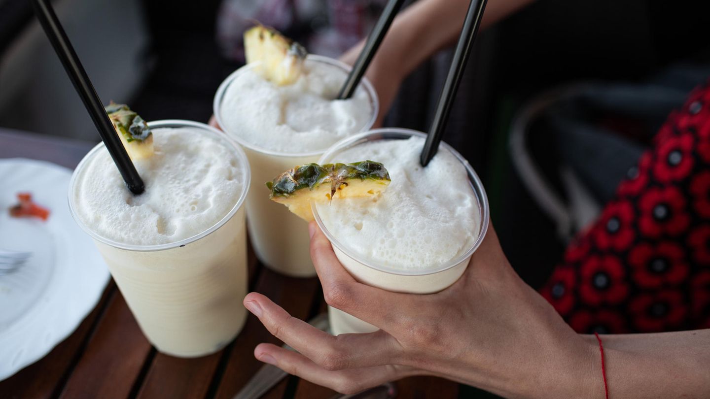 Drei Becher mit Pina Colada stehen auf einem Tisch