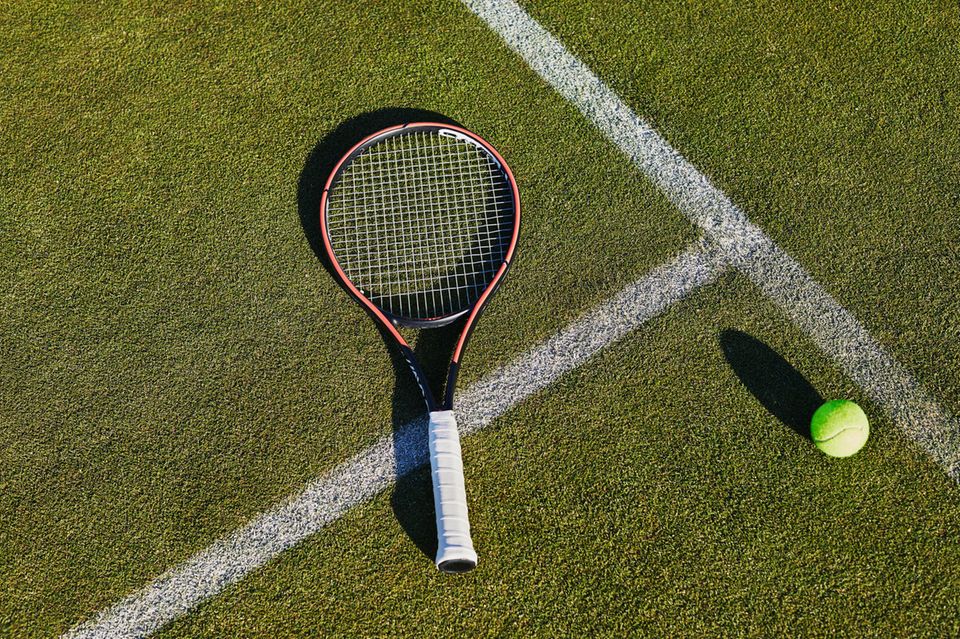A tennis racket and a tennis ball are in a place - tennis is Prince Loui's hobby