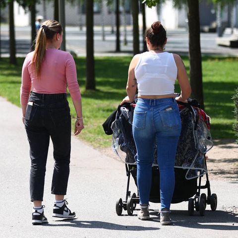 Zwei junge Frauen gehen mit einem Kinderwagen spazieren (Symbolbild)