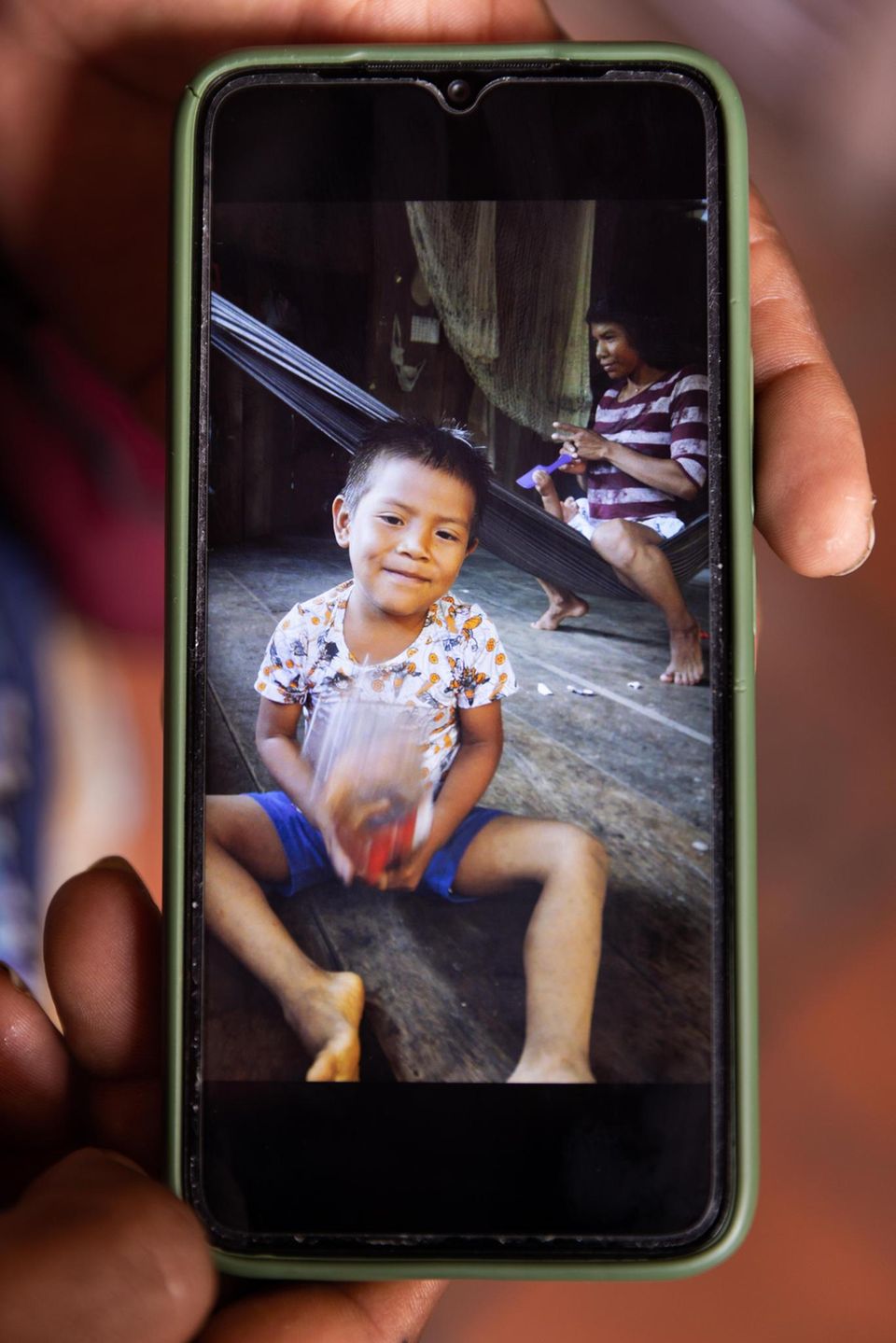 Tien before the crash in the house of the family, his mother in the background