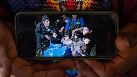 Together again after 40 days in the rain forest: Father Manuel Ranoque shows a picture on his cell phone of himself and his four children
