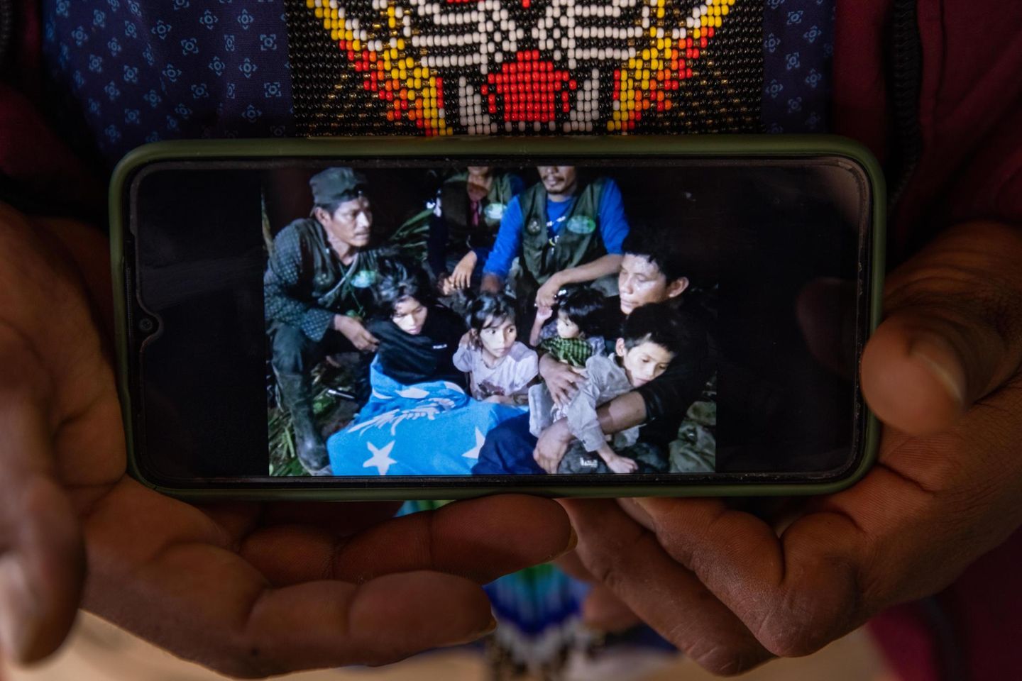Together again after 40 days in the rain forest: Father Manuel Ranoque shows a picture on his cell phone of himself and his four children