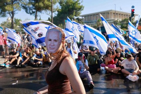 Eine Frau protestiert mit Netanjahu-Maske gegen die geplante Justizreform der Regierung