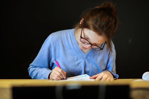 Schulbuch.Studie Bremen: Ein Mädchen liest in einem Buch