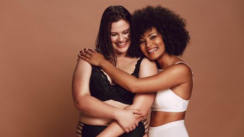 Zwei Frauen umarmen sich in Dessous