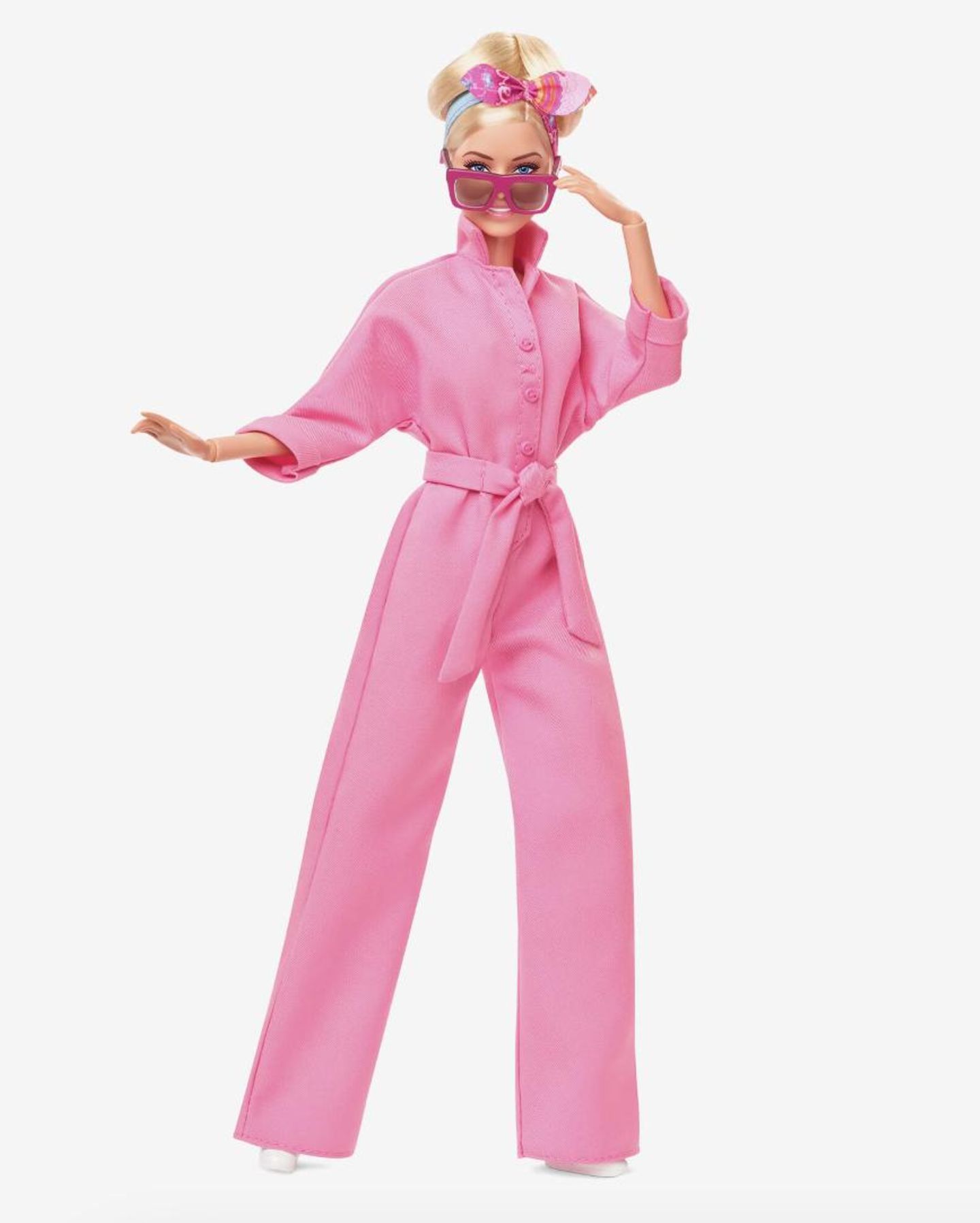 Auch die Puppe ist im pinken Overall inklusive Haarband und Sonnenbrille verfügbar.