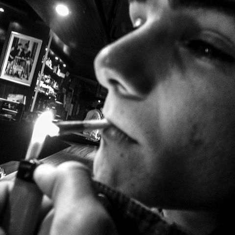 Gen z. versus generation X. A young man smokes