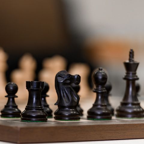 Schachfiguren stehen vor Spielbeginn auf dem Schachbrett