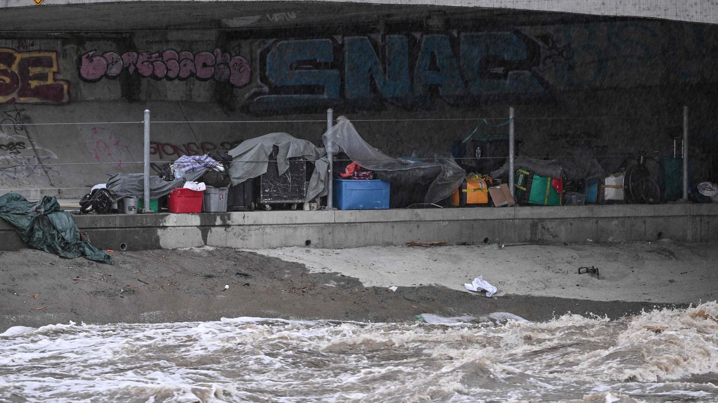In der Nähe des reißenden Los Angeles River haben Obdachlose versucht, ihre Zelte und Besitztümer zu sichern. 
